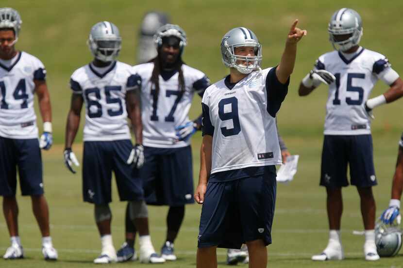Dallas quarterback Tony Romo (9) directs a drill during Dallas Cowboys minicamp held at...
