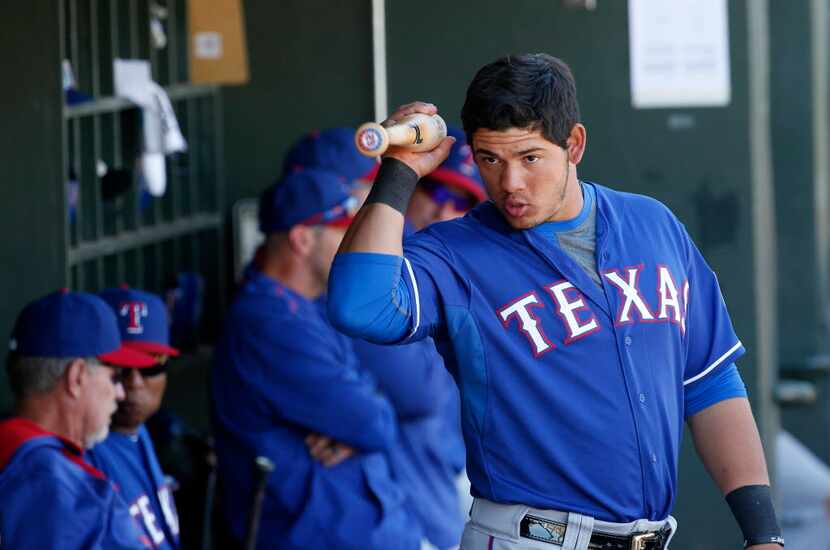 Texas Rangers catcher Jorge Alfaro speaks to a teammate in the dugout during a Major League...