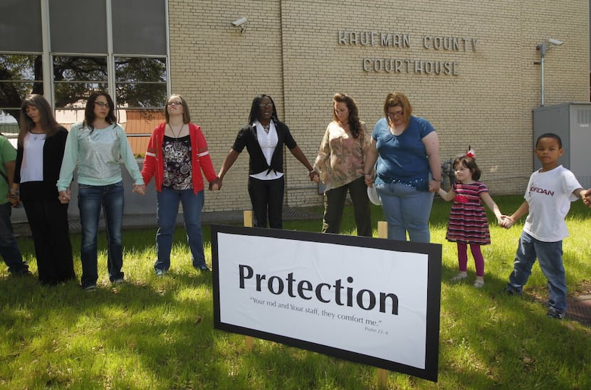 Residents take part in a prayer walk around the Kaufman County Courthouse in Kaufman, Texas...