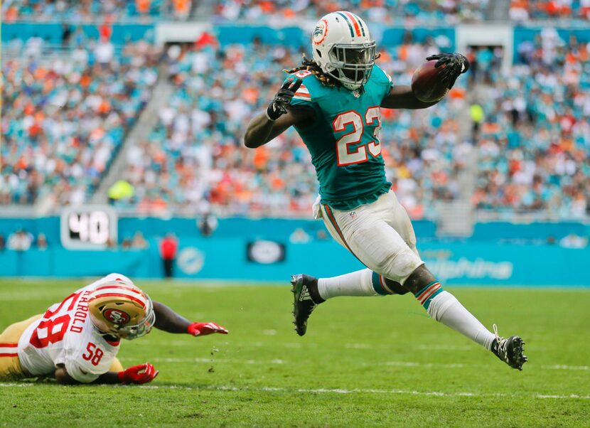 Miami Dolphins running back Jay Ajayi (23) runs into the end zone in the second quarter...