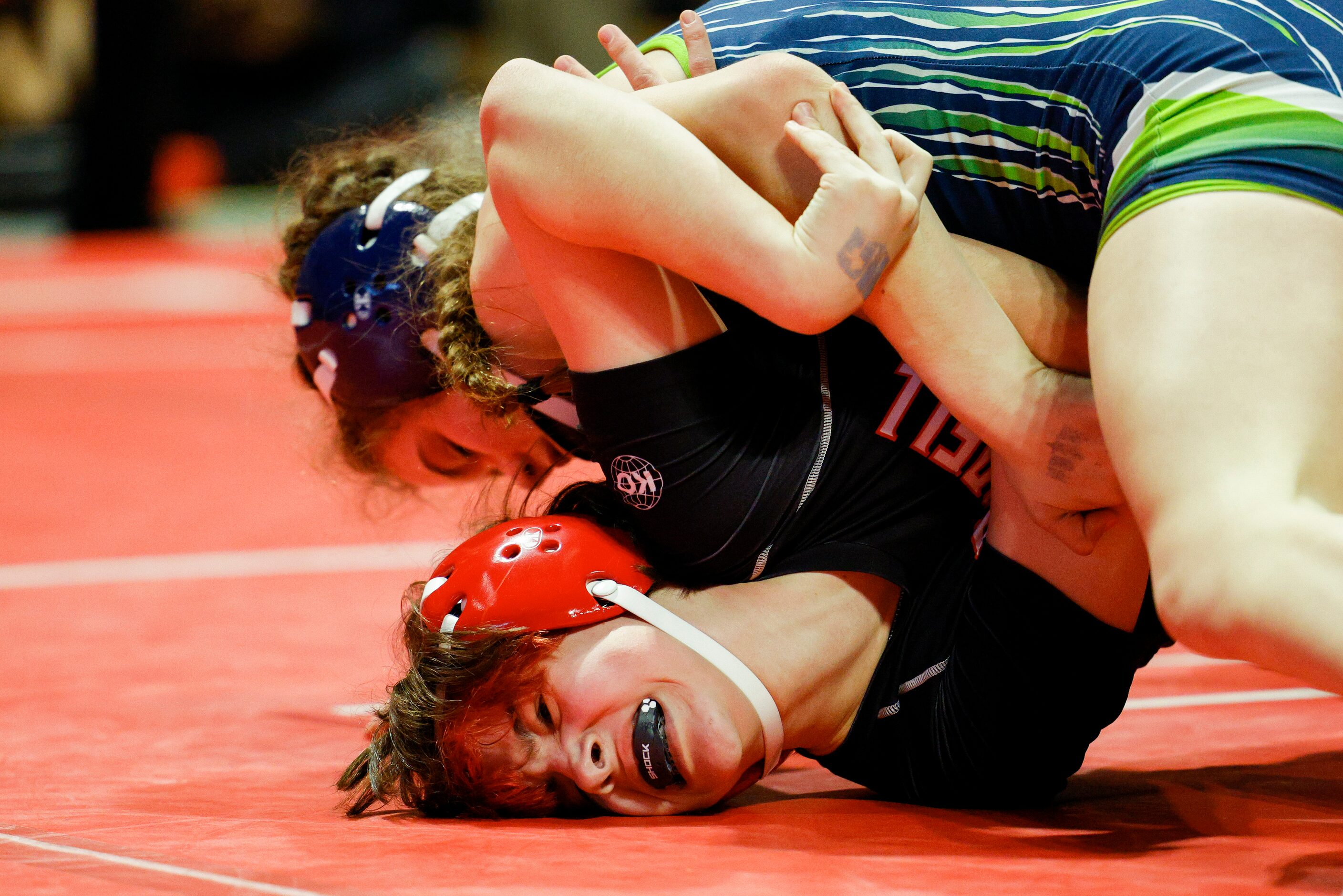 Scout Carrell of Coppell (bottom) wrestles Neelie Parker of Northwest Eaton during a...