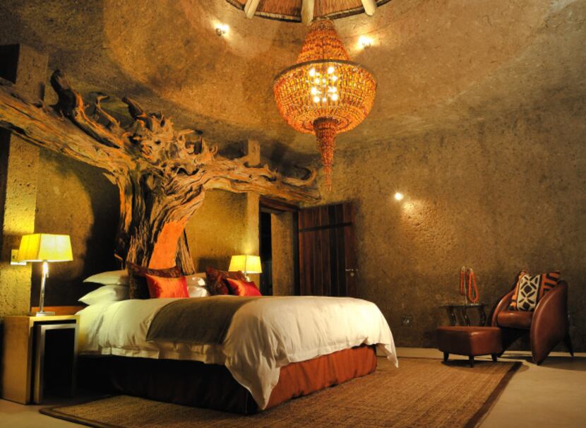 Earth Lodge's Amber Suite features a carved wooden headboard and a deep egg-shaped bath,...