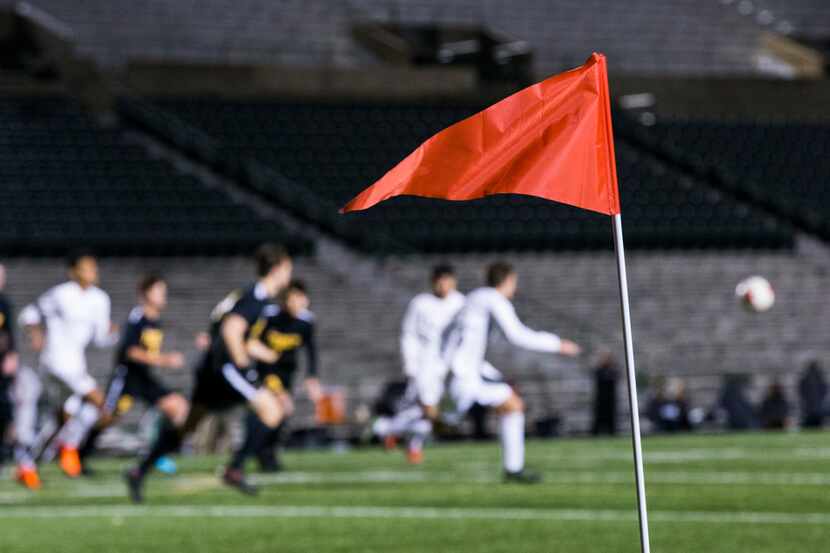 A red sideline flag waves at a corner of the field during a soccer game between Forney High...