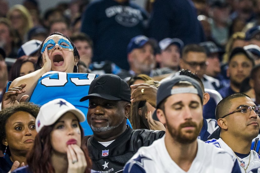 A Carolina Panthers fans celebrates after middle linebacker Luke Kuechly intercepted a pass...