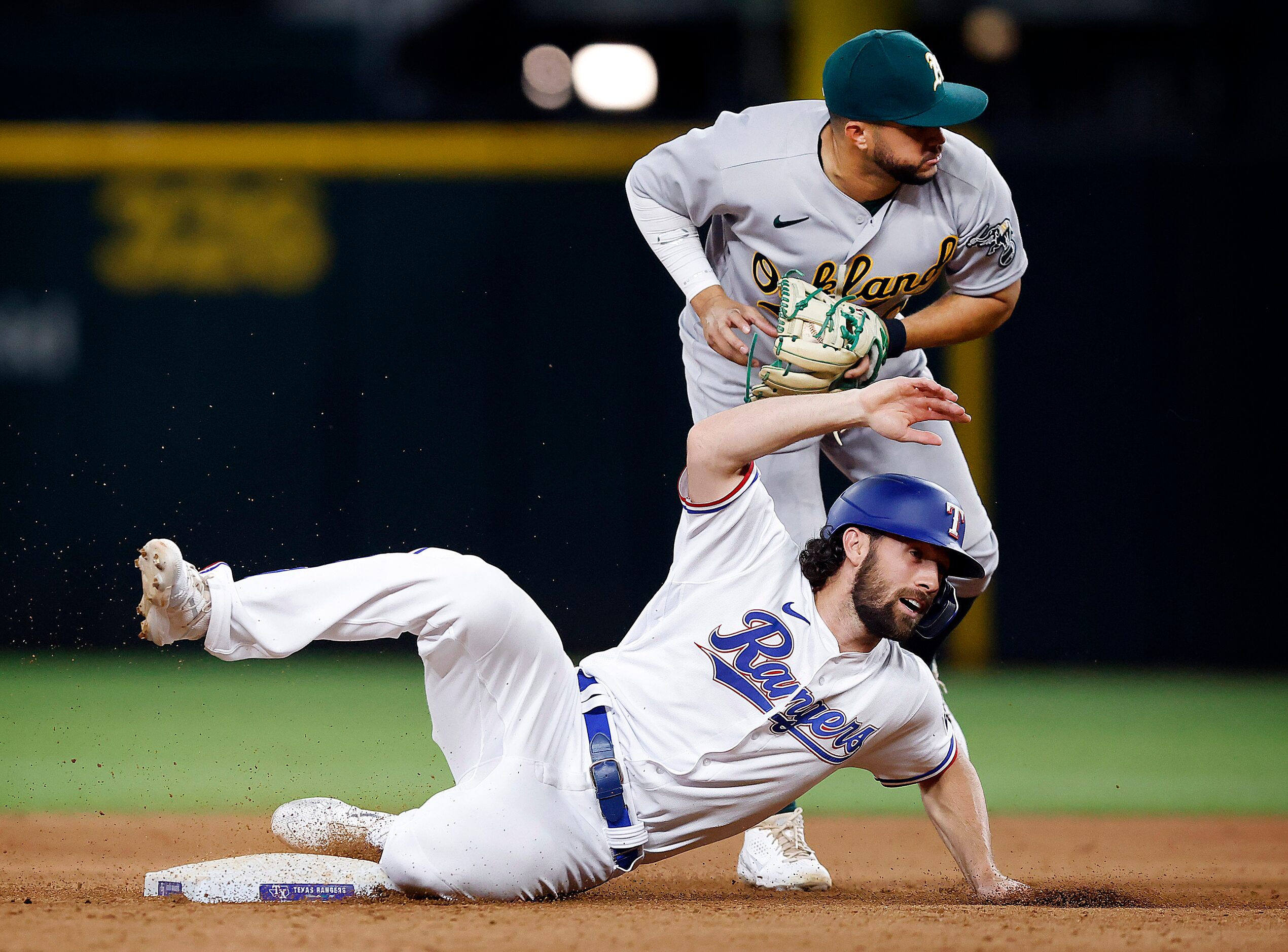 Texas Rangers Charlie Culberson (2) slides out after being tagged by Oakland Athletics...