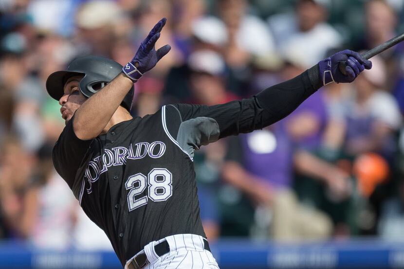 DENVER, CO - AUGUST 7: Nolan Arenado #28 of the Colorado Rockies hits a fourth inning...