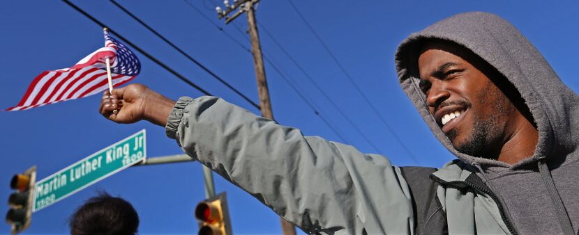 Izaih Franklin waved an American flag as he watched the annual MLK Day parade in Dallas in...