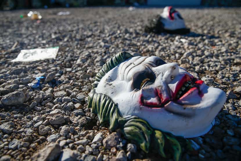 Halloween masks littered the ground among signs of chaos at the scene where a mass shooting...
