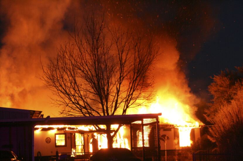 A neighbor photographed the blazing trailer where six people were killed.