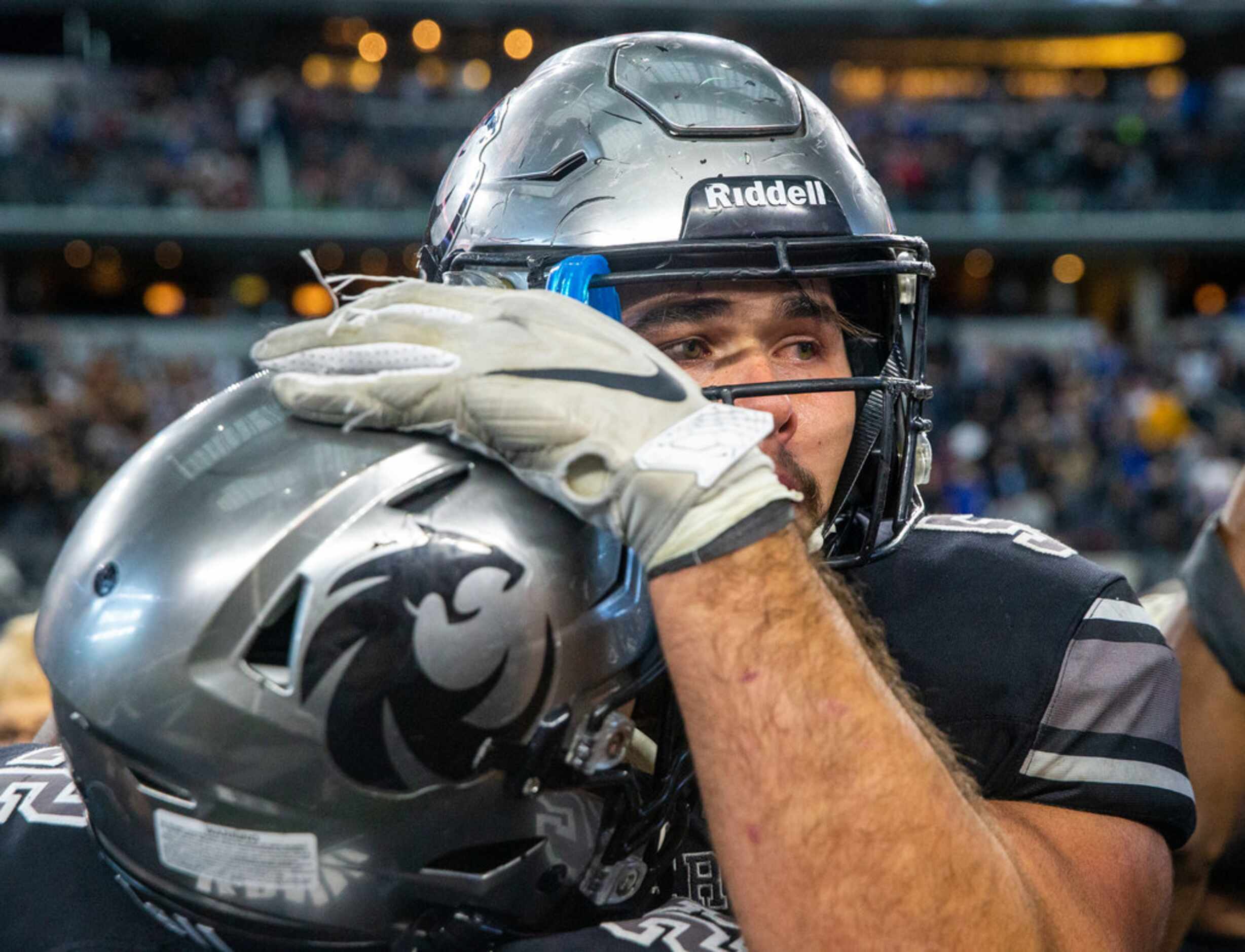 Denton Guyer offensive lineman Grant Mahon (center) cries after his team wins against Cedar...