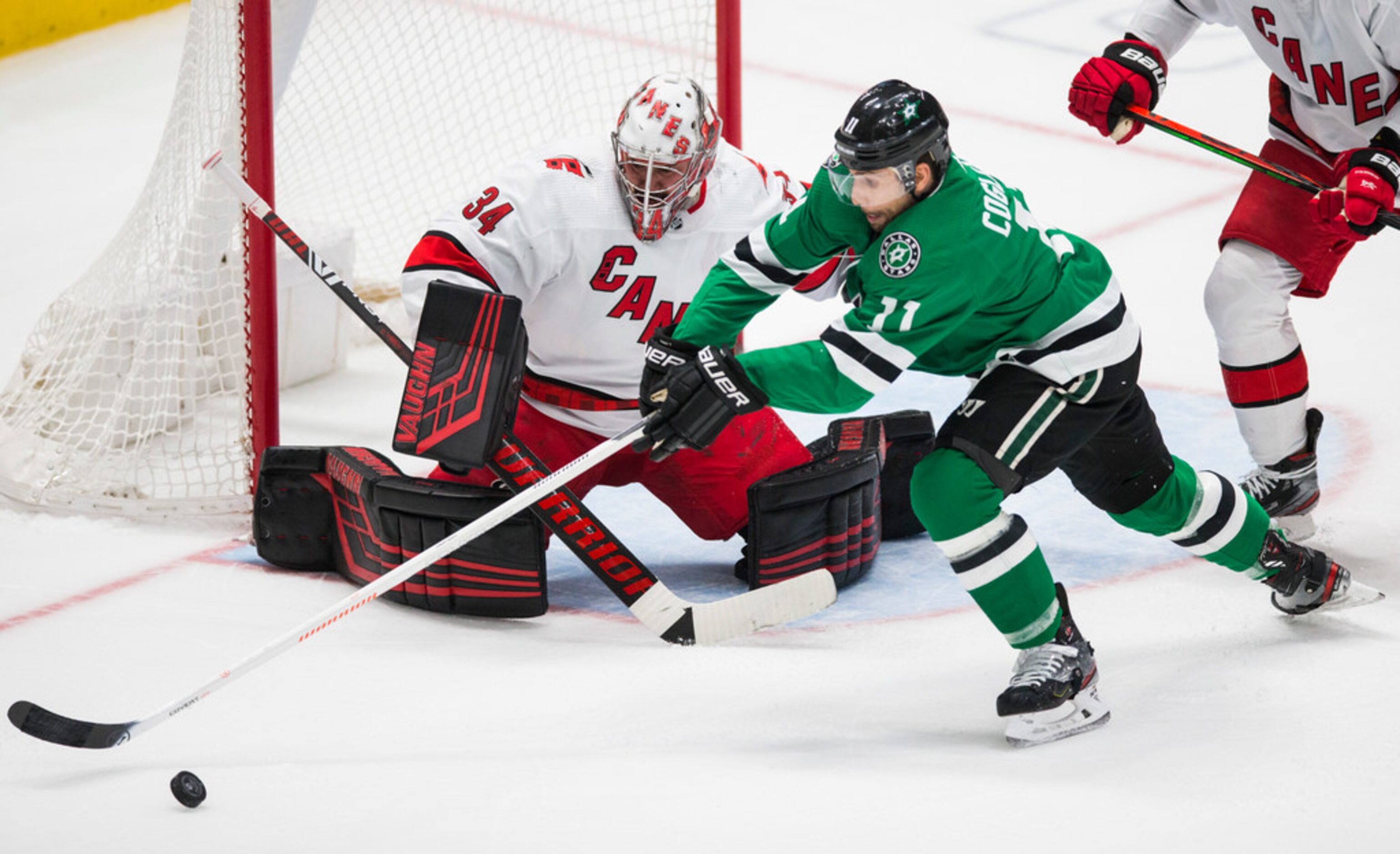 Dallas Stars center Andrew Cogliano (11) stretches for the puck in front of Carolina...