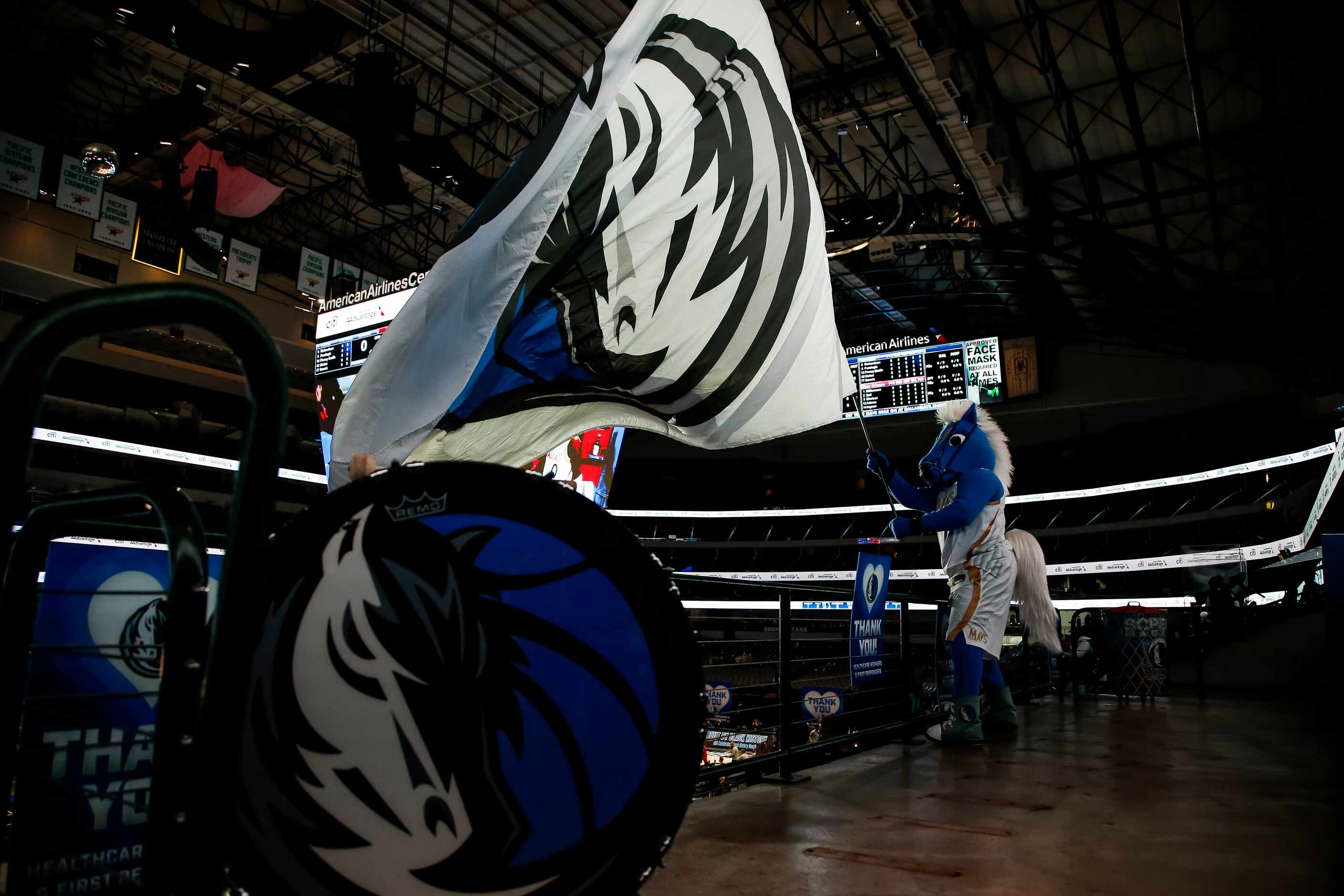 Dallas Mavericks mascot, Champ, rallies fans before the start of an NBA basketball game...