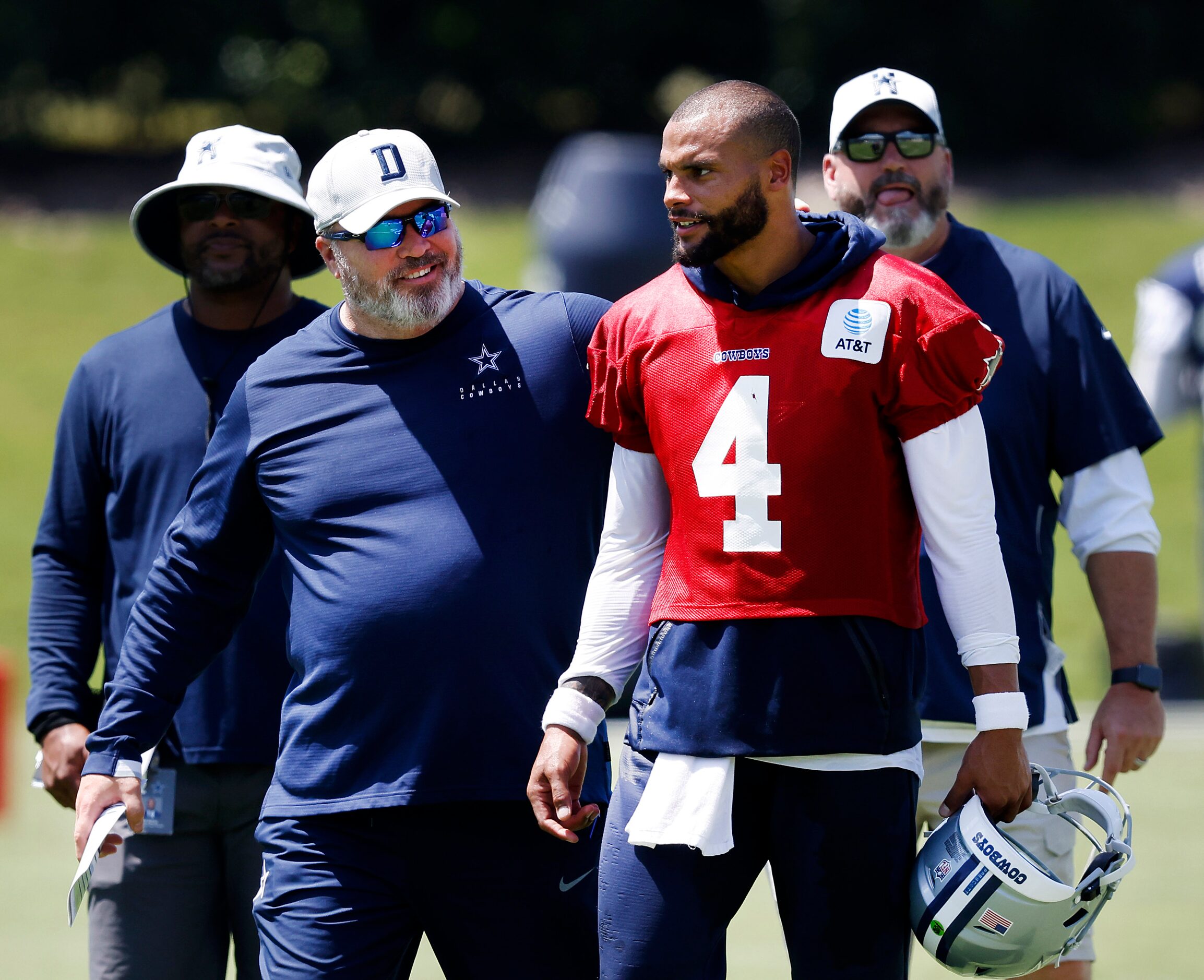 Dallas Cowboys head coach Mike McCarthy pats quarterback Dak Prescott (4) on the back...