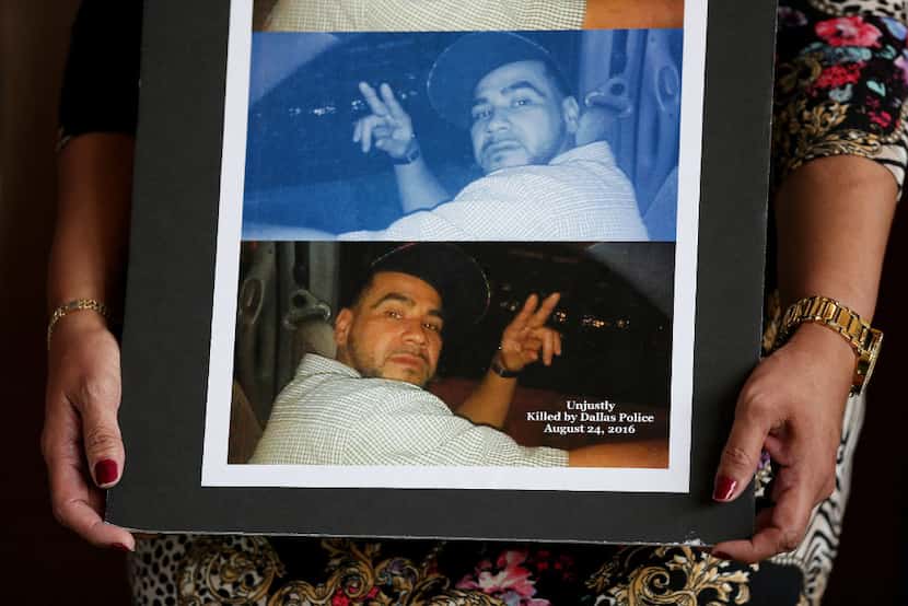 Lorenza Olivares, sister of Elias Portillo, holds pictures of her brother at a press...