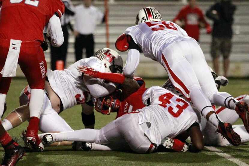 
Players from Dallas Skyline and Lake Highlands high schools are shown during a game last...