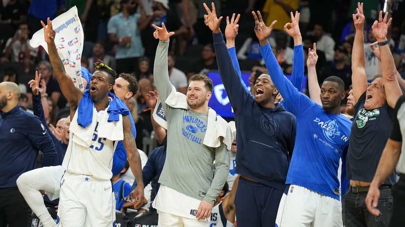 Dallas Mavericks players (from left) Reggie Bullock (25), Dwight Powell (behind Bullock),...