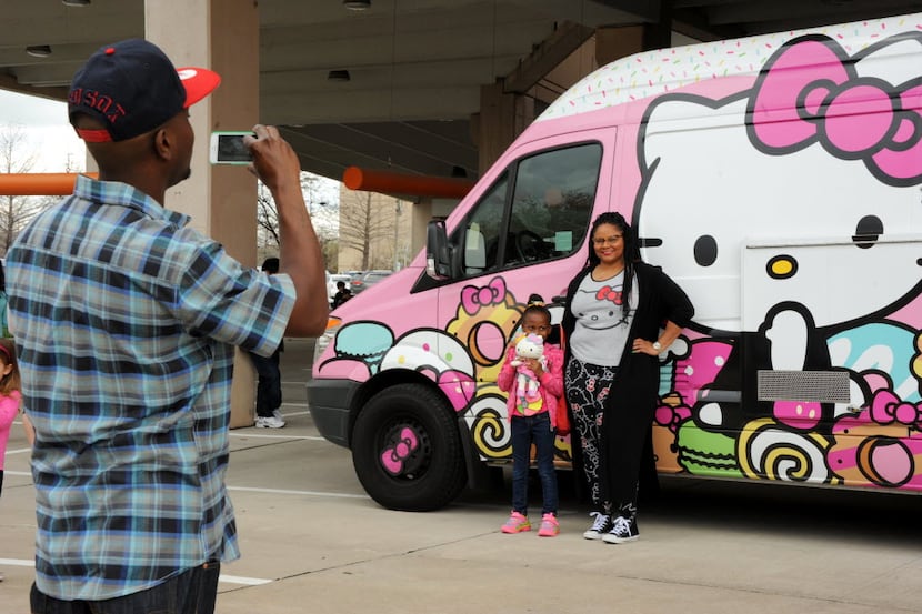 Dakota Bradford and Devon Warner pose for a picture with the famous truck at the Hello Kitty...