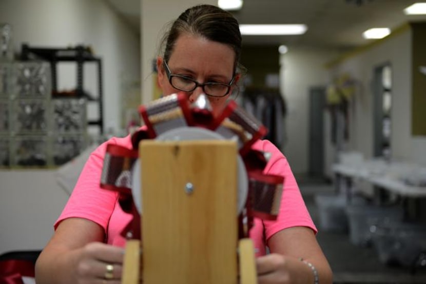 Amy Adams, a member of the Planoette Mum Moms at Plano Senior High School, works on a...