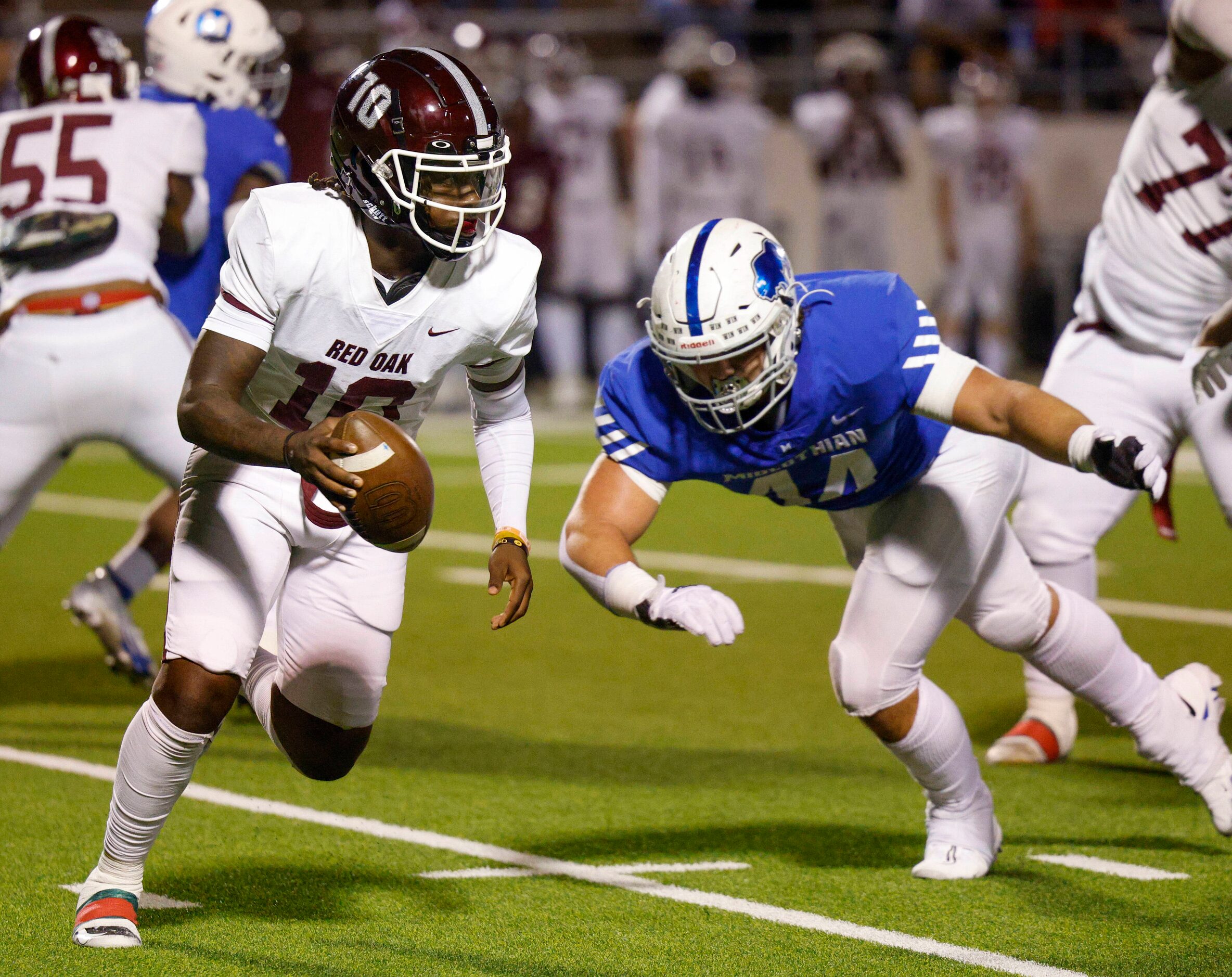 Midlothian defensive lineman Bradyn Smith (44) pressures Red Oak quarterback Jaylon Robinson...