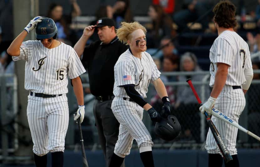 Keller's Fisher Polydoroff (19), center, reacts after crossing home plate to complete a...