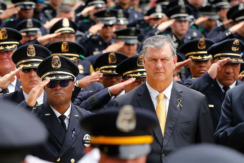 Dallas Mayor Mike Rawlings stands with Dallas police Chief David Brown (left, with...