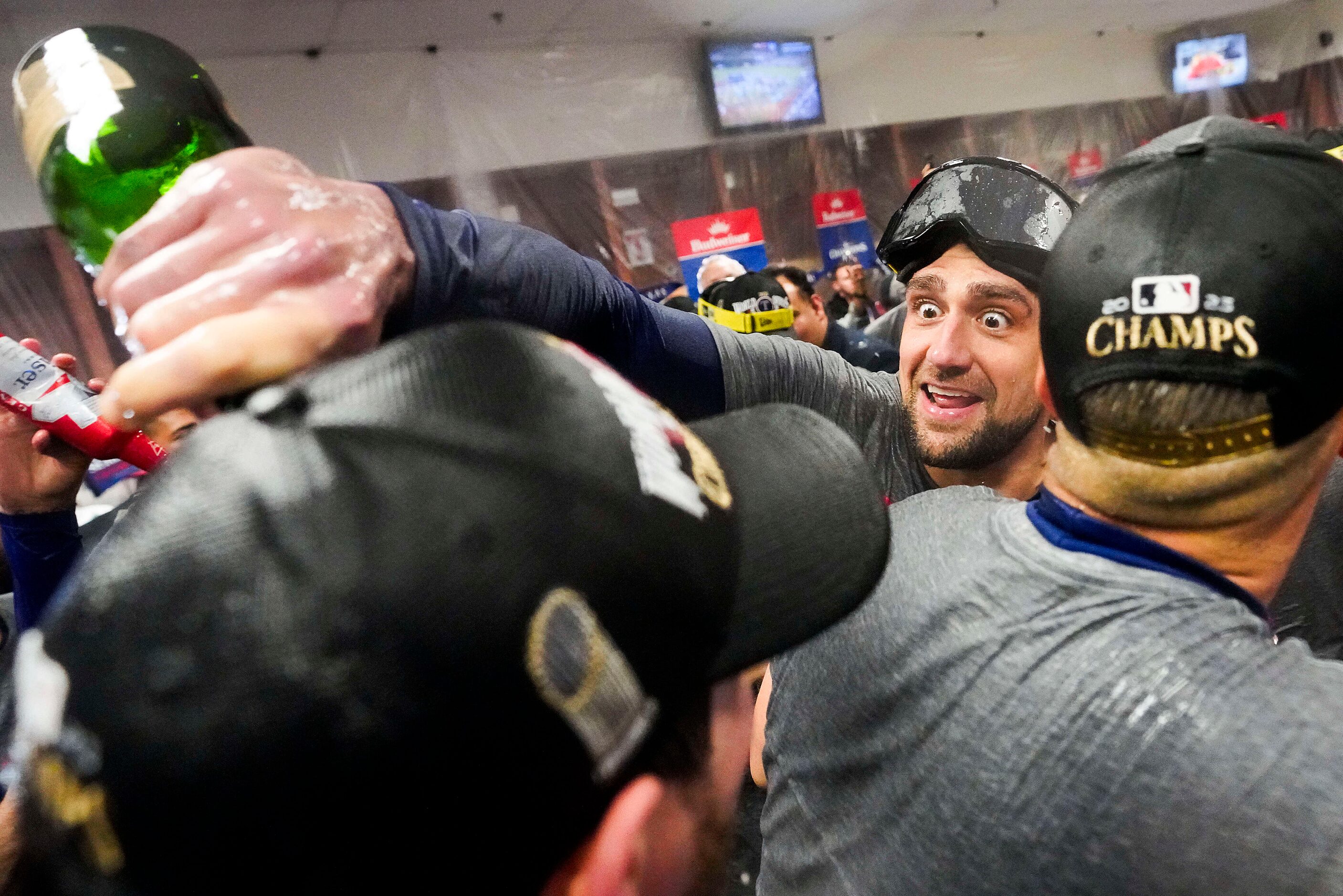 Texas Rangers starting pitcher Nathan Eovaldi douses teammates in the clubhouse as Rangers...