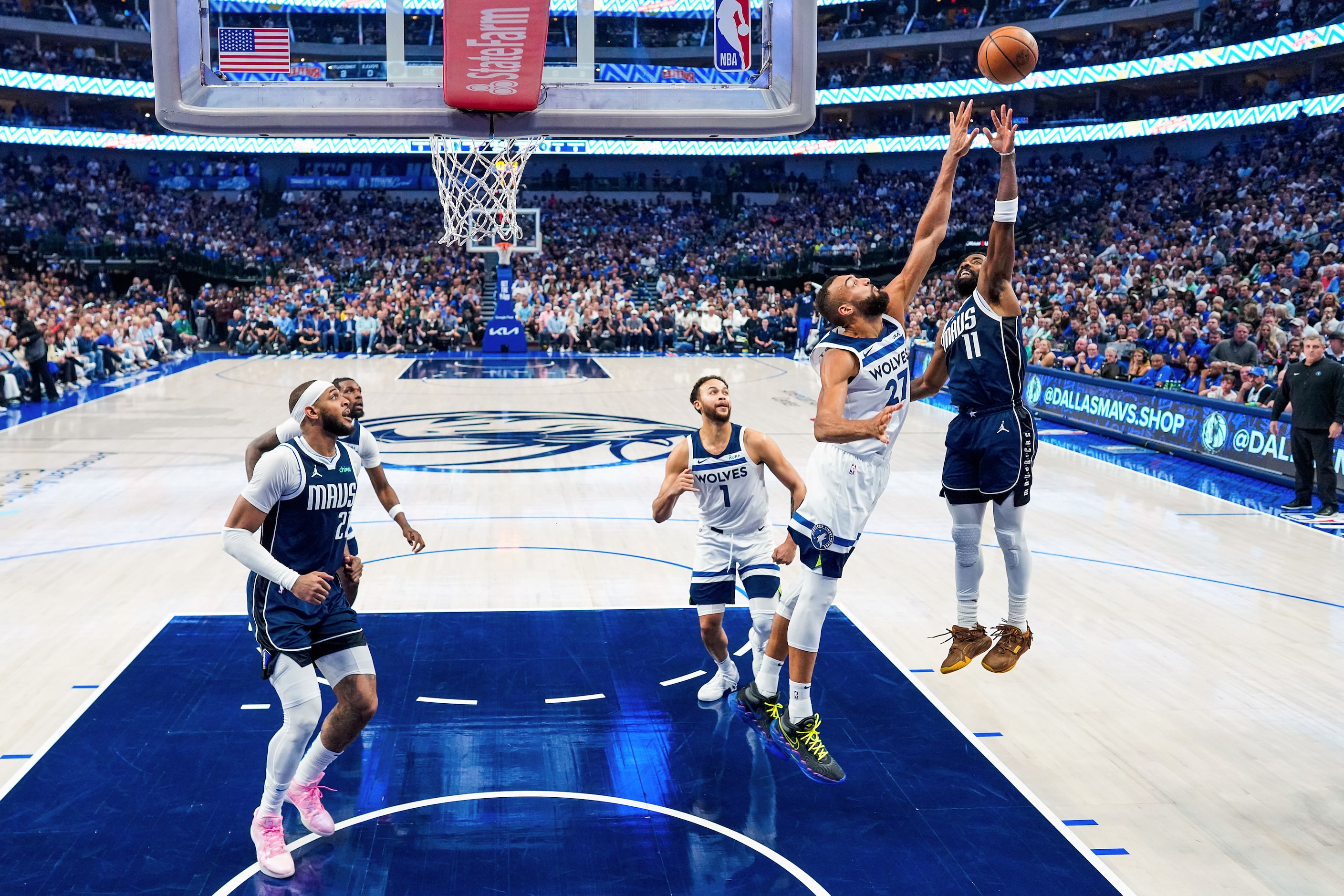 Dallas Mavericks guard Kyrie Irving (11) shoots over Minnesota Timberwolves center Rudy...