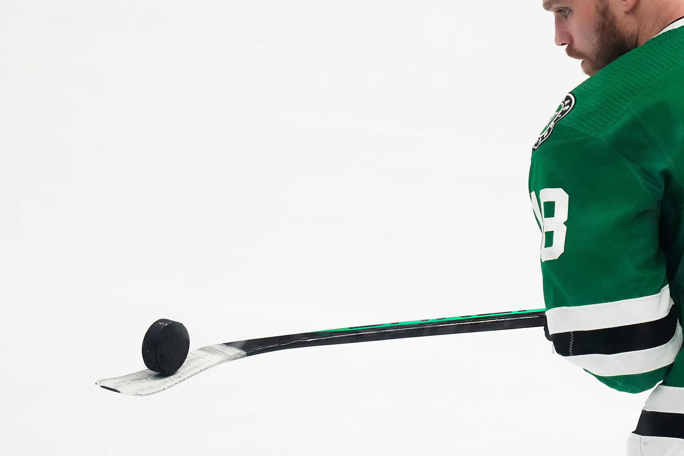 Dallas Stars center Max Domi balances a puck on his stick as the team warms up before Game 6...