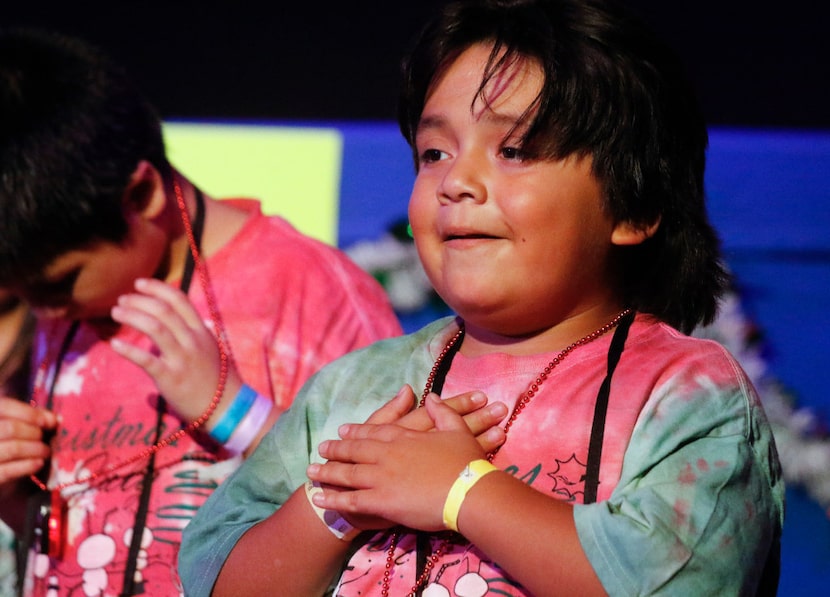 Matthew Rojas, 9, performs with fellow campers at Camp Bravo.
