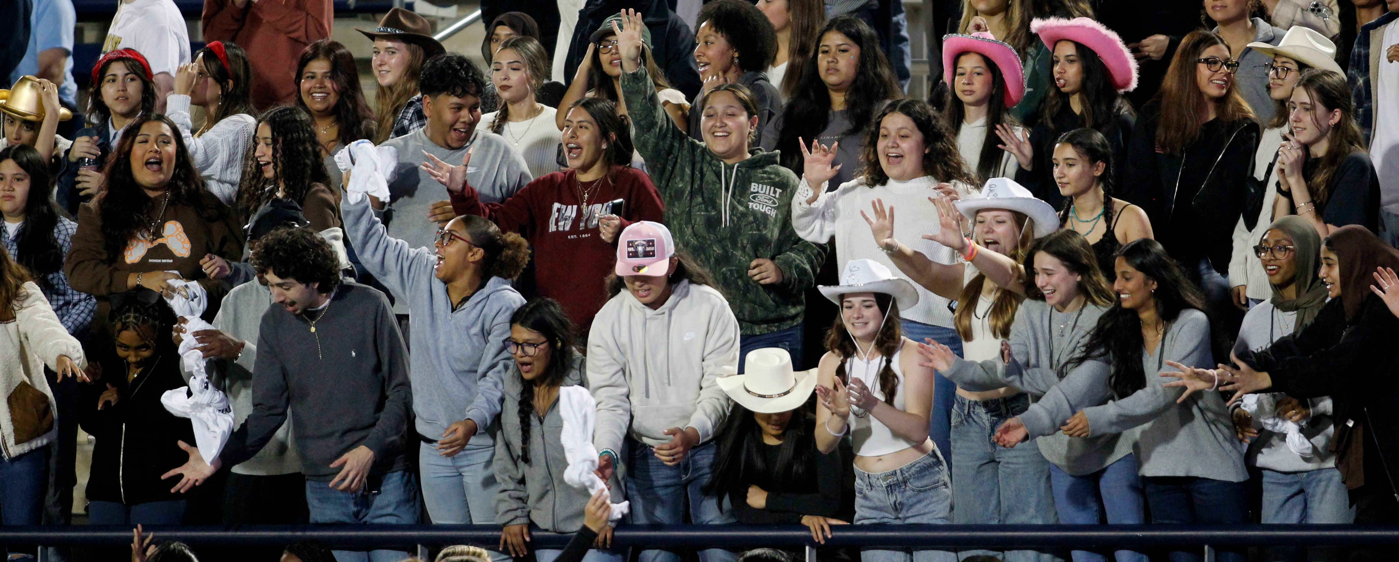 Fans filling the stands in the Plano East students section get excited at the possibility to...