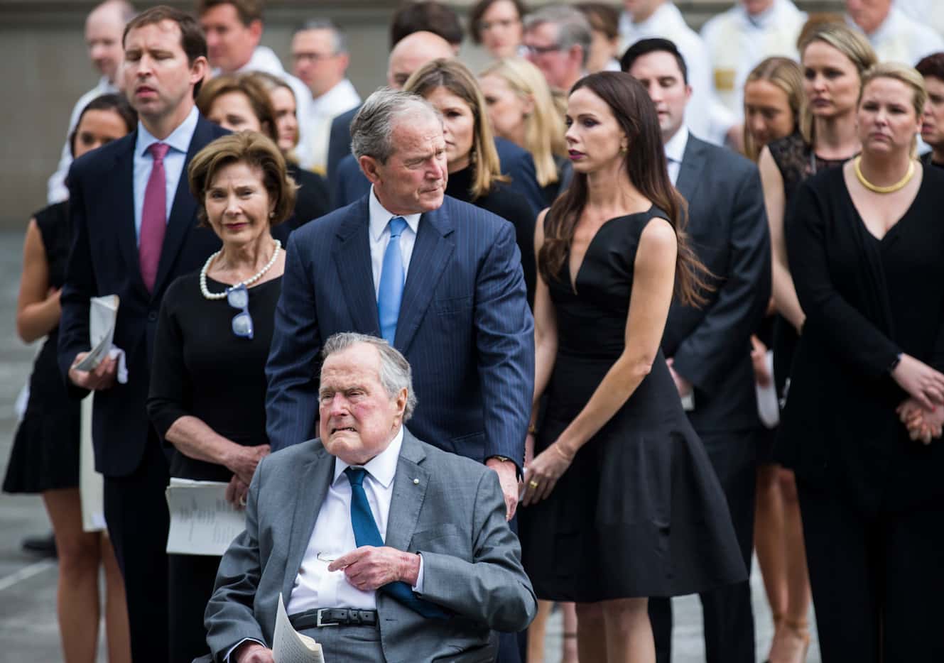 Former President George H.W. Bush is escorted out of St. Martin's Episcopal Church in...