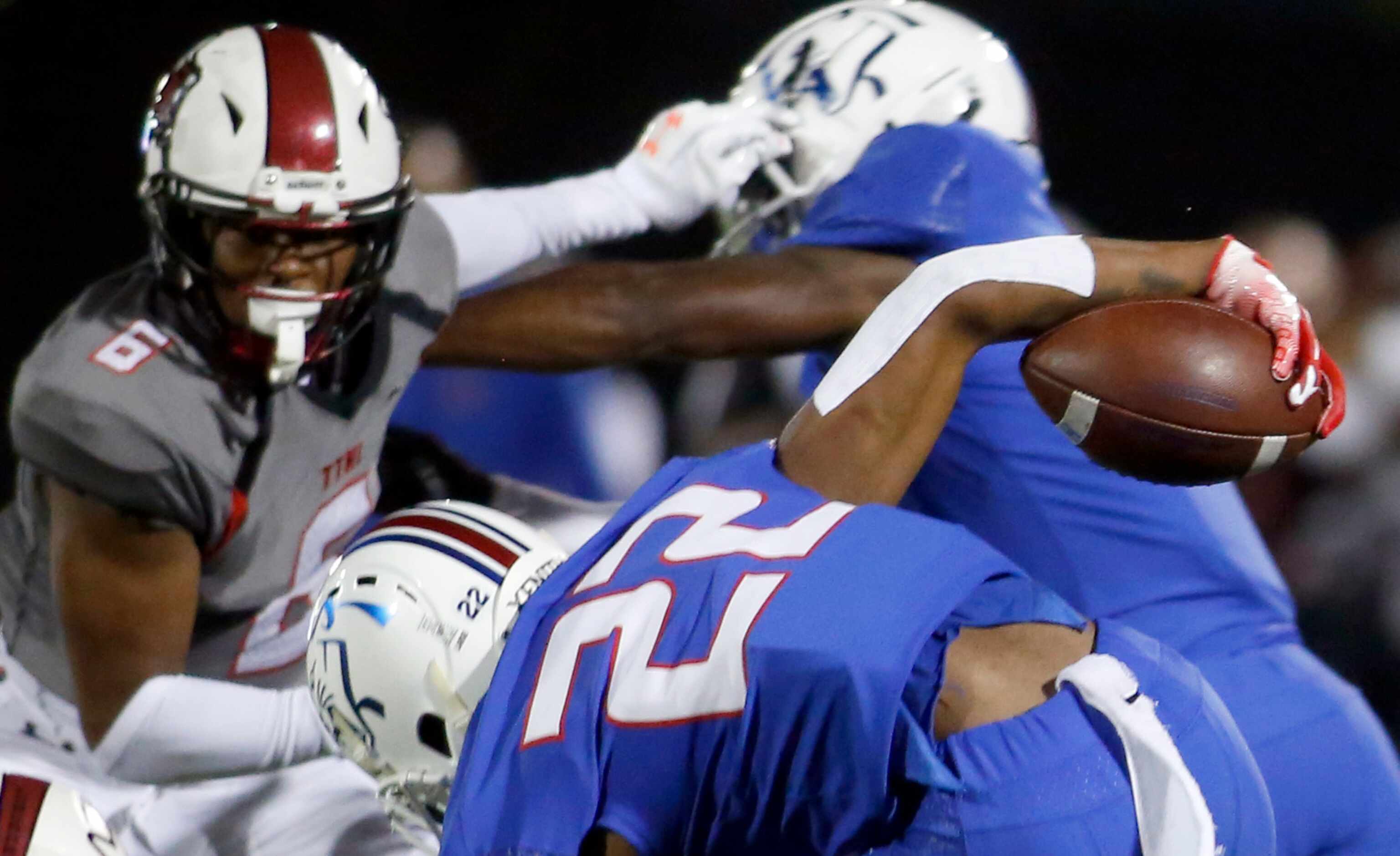 Duncanville receiver Lontrell Turner (22) maintains ball control as he battles to maintain...