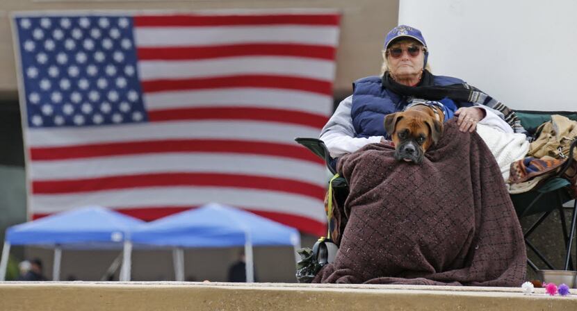 Ozla Tucker and  her dog Sampson watch the Dallas Veterans Day Parade pass by Dallas City...