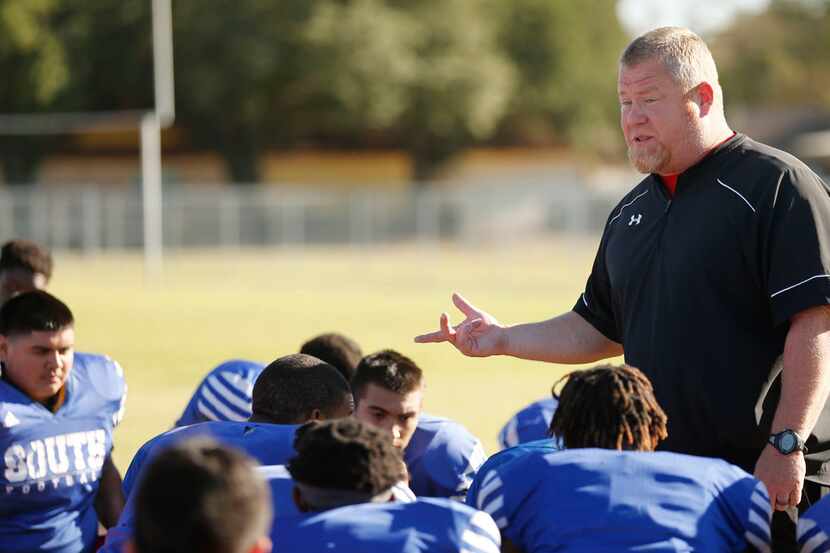South Garland football coach Josh Ragsdale talks to his players after practice last season....
