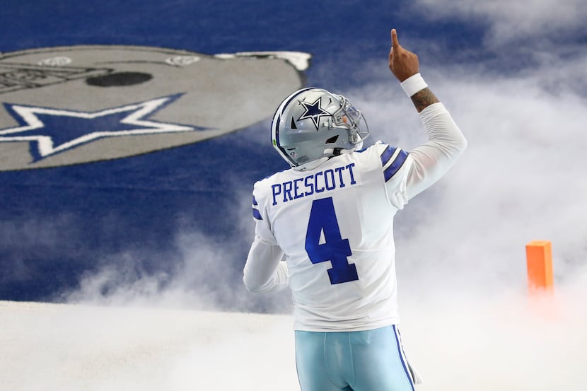 Dallas Cowboys quarterback Dak Prescott (4) points up as he takes the field during...