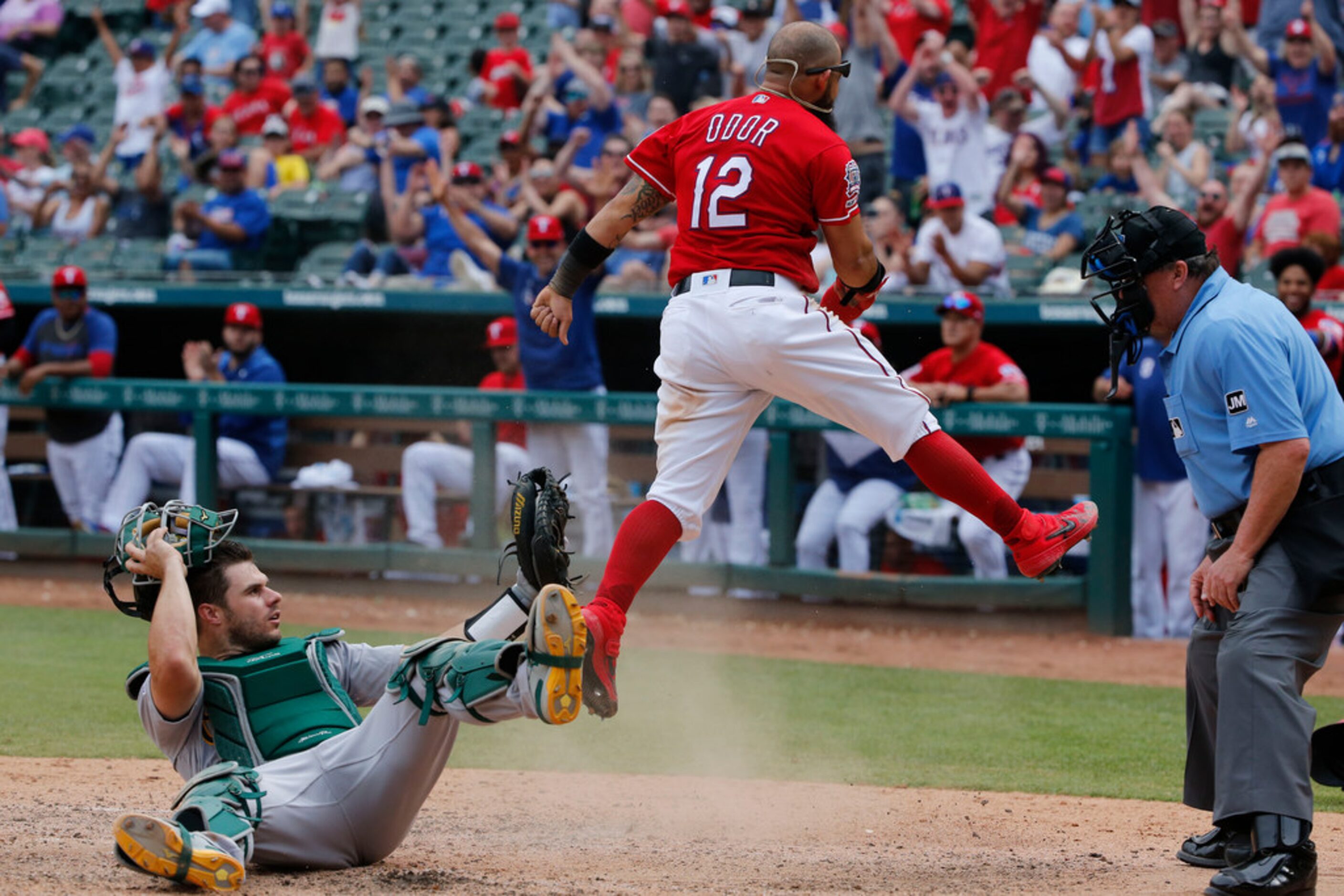 Texas Rangers' Rougned Odor (12) celebrates after stealing home as Oakland Athletics catcher...