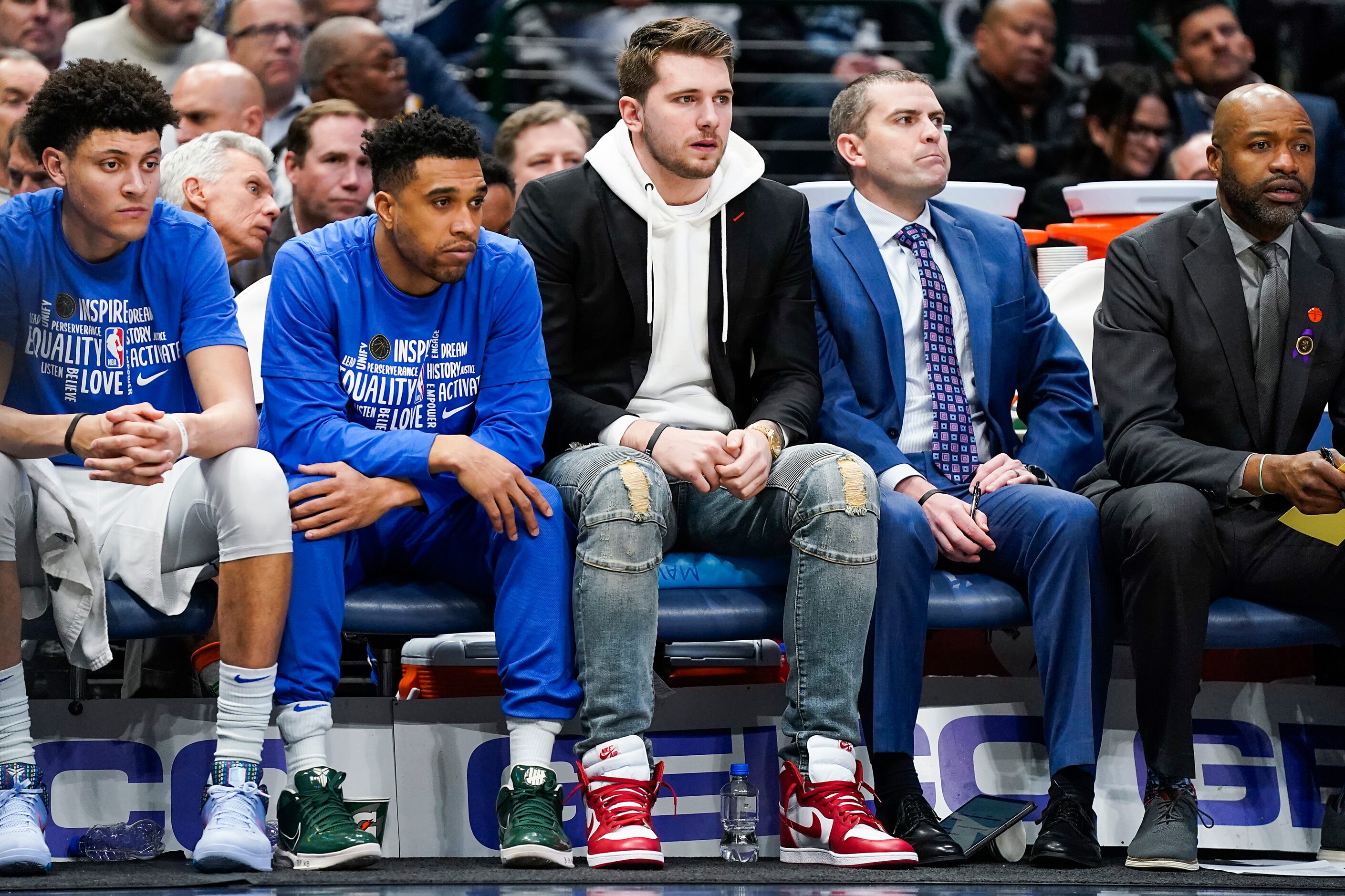 Injured Dallas Mavericks guard Luka Doncic watches from the bench during the first half of...