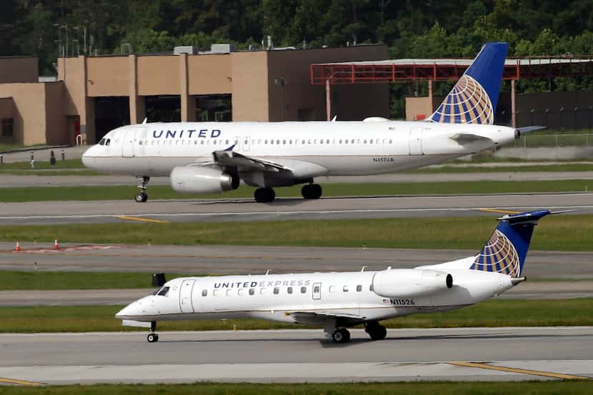 FILE - In this July 8, 2015, file photo, United Airlines and United Express planes prepare...