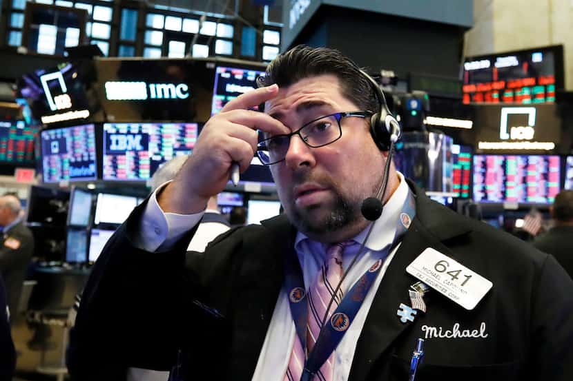 Trader Michael Capolino works on the floor of the New York Stock Exchange, Thursday, Oct....