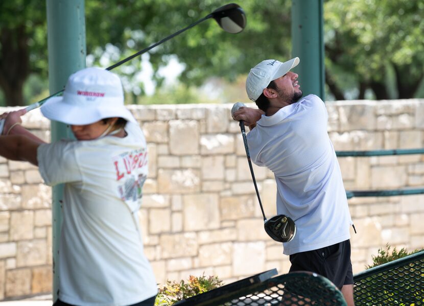 Jacobs Yetts (left), 15, and his brother Josh Yetts, 19, practice their golf swings at the...