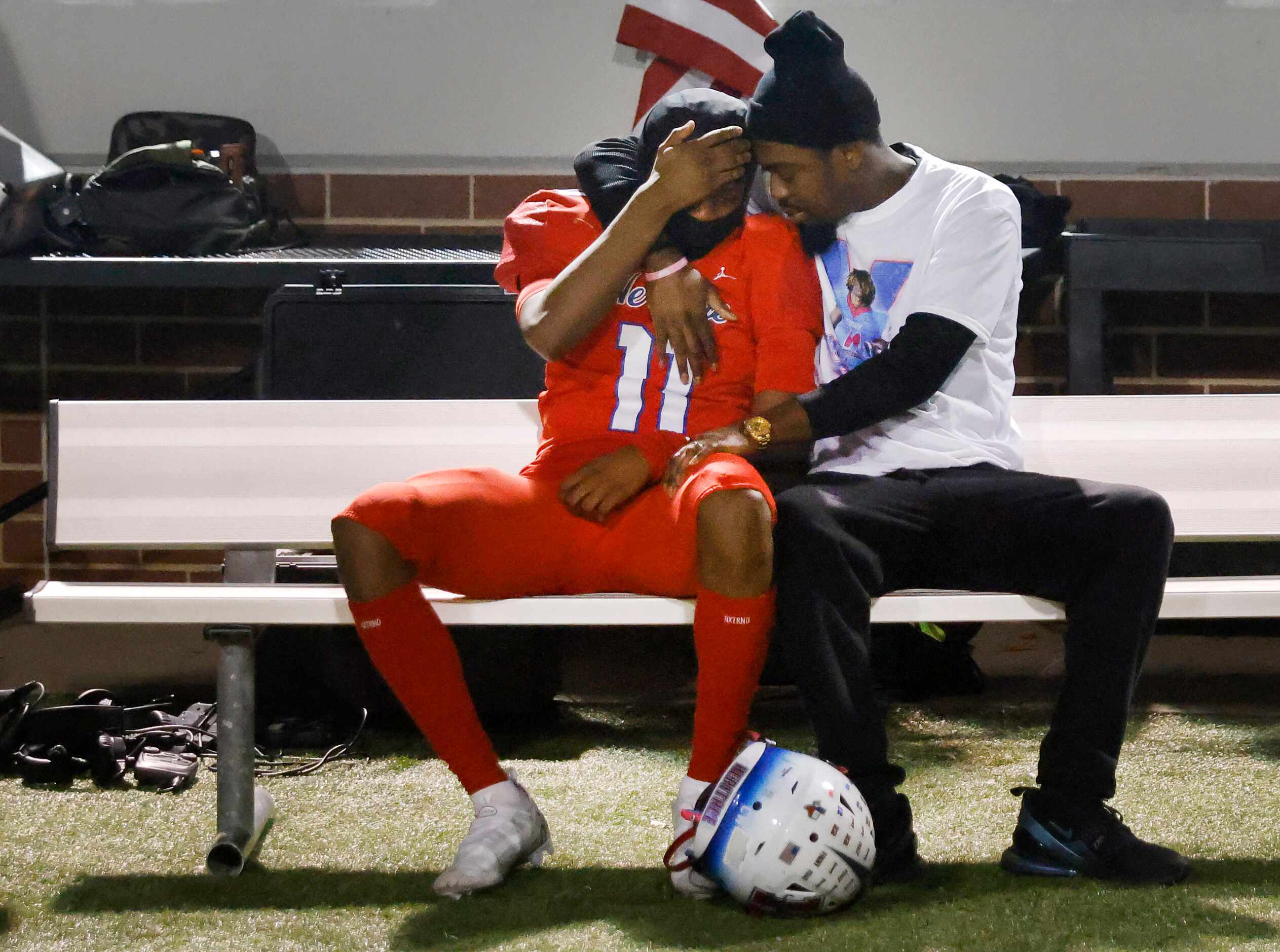 Midlothian Heritage senior wide receiver Xavier Moten (11) is comforted on the bench after...