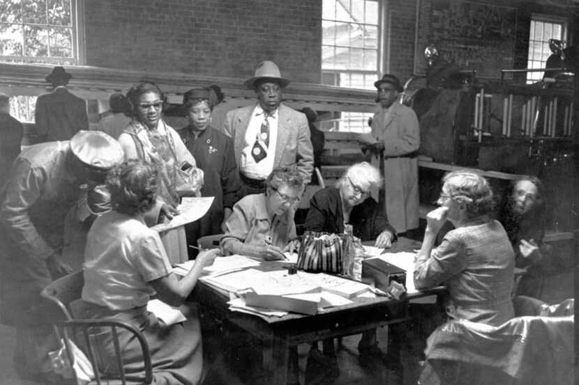 Voters cast ballots at a polling station in a firehouse, after black people were granted the...