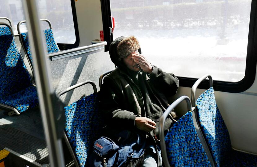 
Artis Frank rubs his face during the last leg of his commute on a DART bus.

