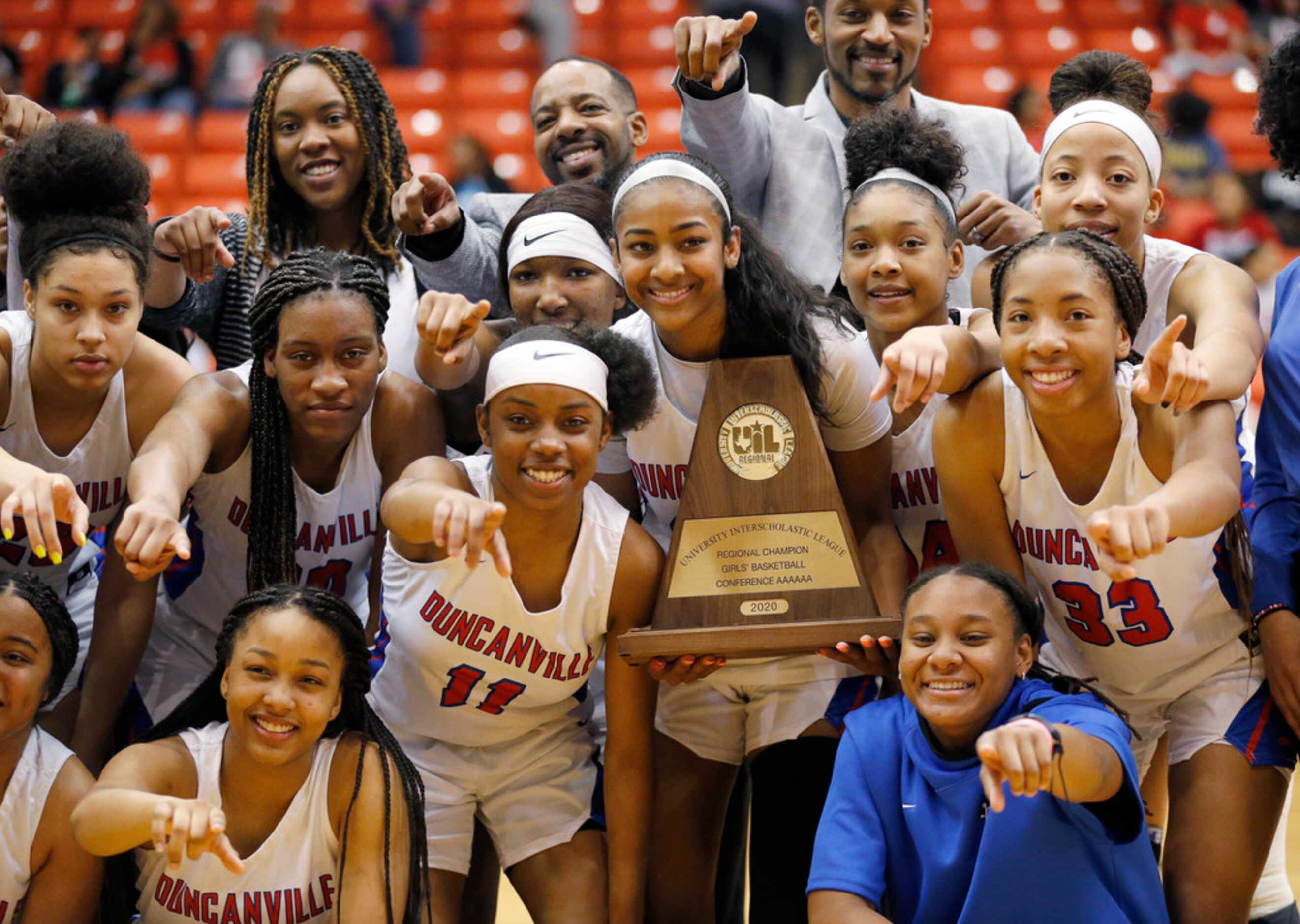 The Duncanville girls basketball team poses for photos with the Class 6A Region I...