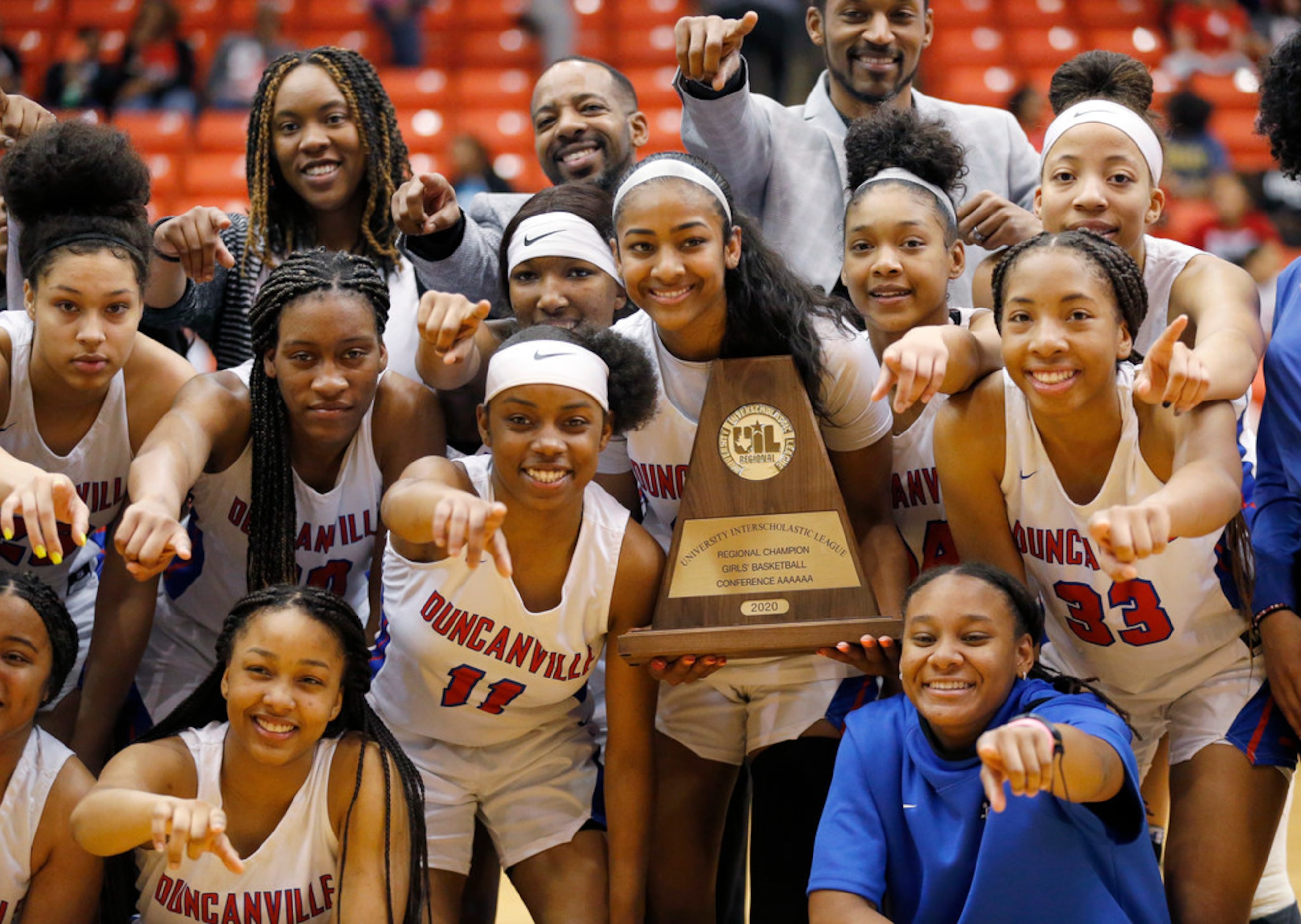 The Duncanville girls basketball team poses for photos with the Class 6A Region I...