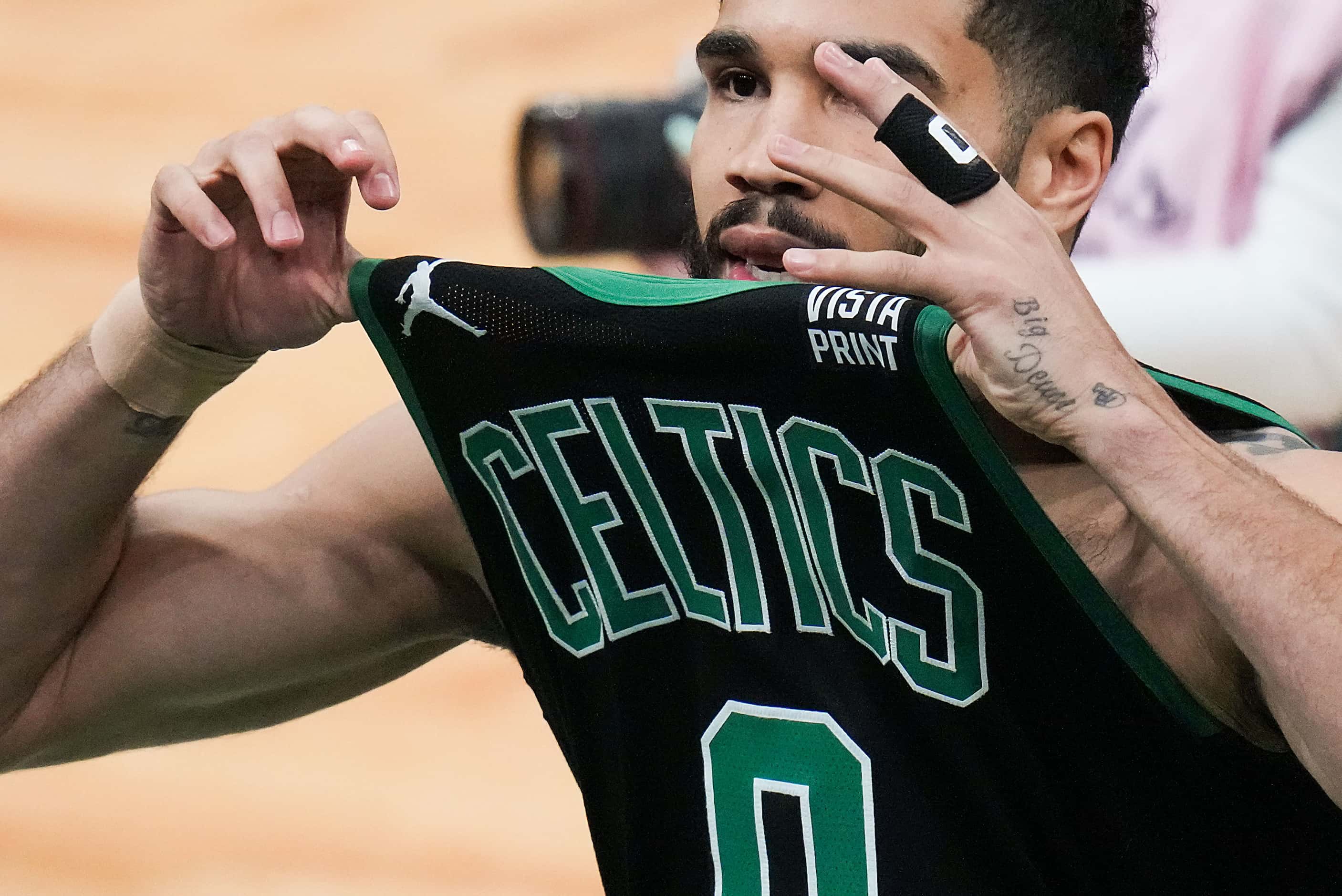 Boston Celtics forward Jayson Tatum (0) gestures to the crowd as he takes the court for the...