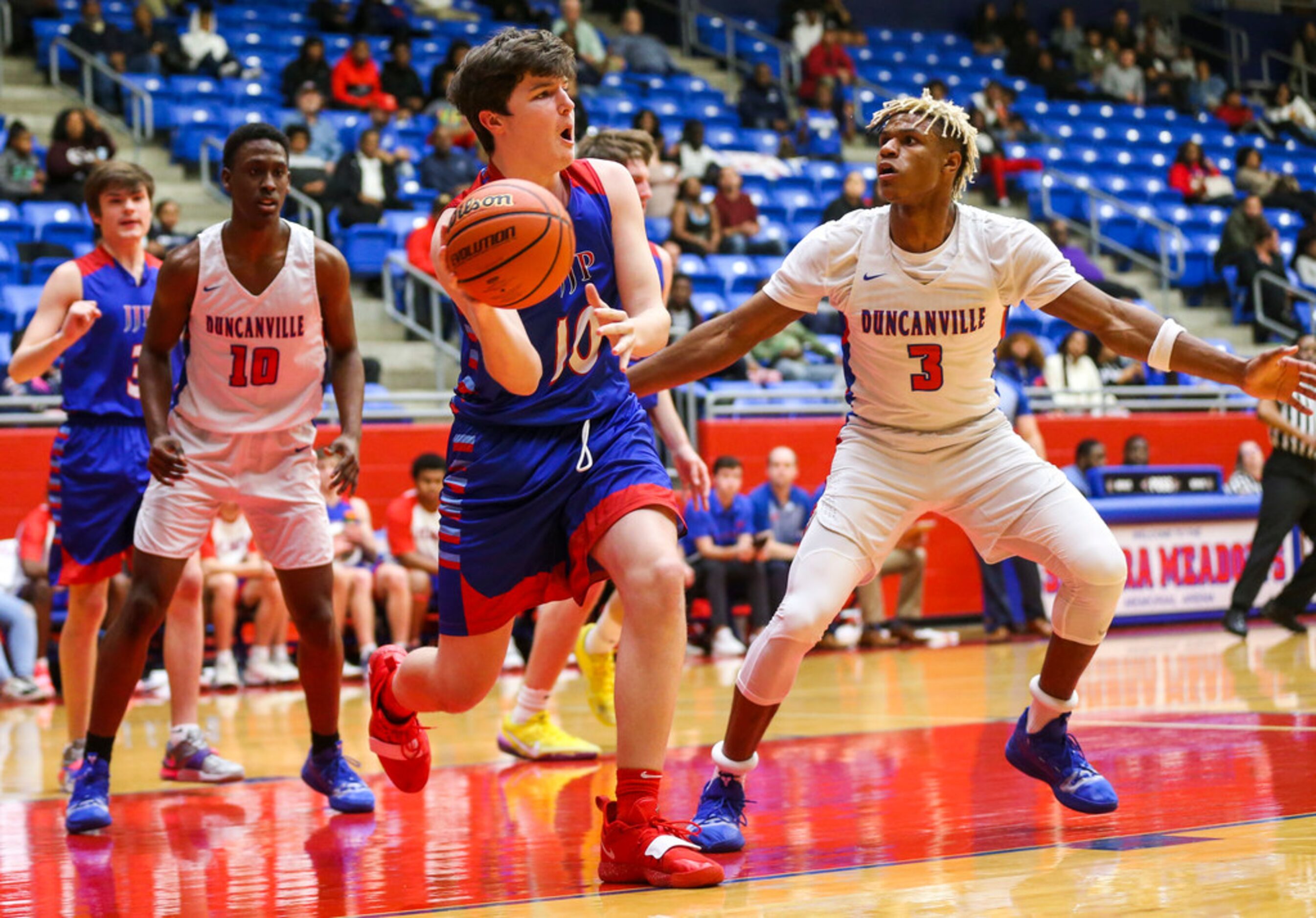 J. J. Pearce forward Walker Timme (10) looks to pass the ball as he is defended by...