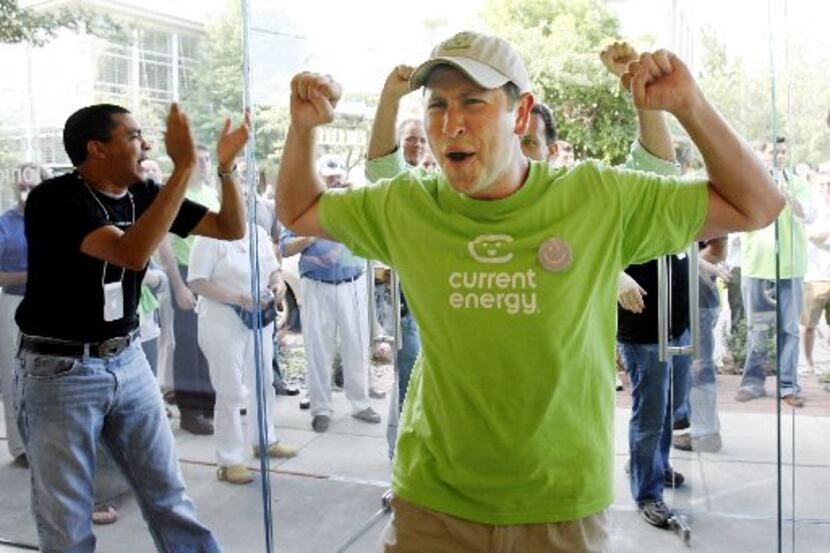 Ben Lack of Dallas celebrates as he enters the Apple Store on Knox Street in Dallas to be...