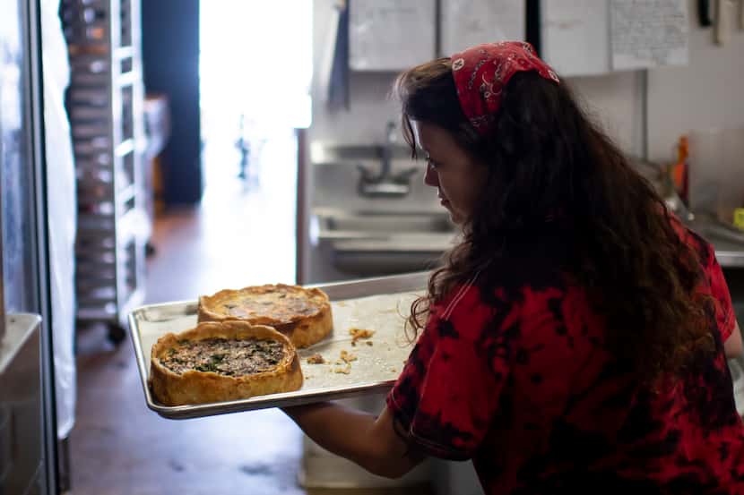 Tyler Hollandsworth takes fresh quiche out of the oven at Leila Bakery & Cafe in Dallas,...