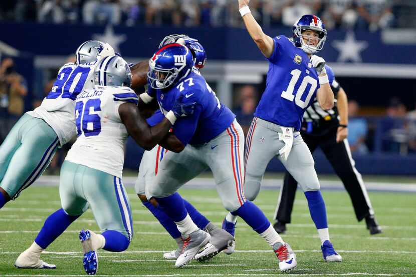 New York Giants quarterback Eli Manning (10) throws a pass from the pocket against the...